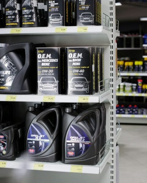 Industrial lubricants Middle East: Shelves stocked with various motor oils, featuring brands like Mannol and Unil, showcasing different viscosities and specifications.