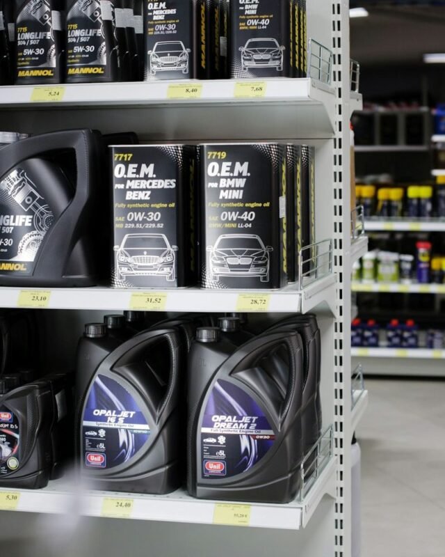 Industrial lubricants Middle East: Shelves stocked with various motor oils, featuring brands like Mannol and Unil, showcasing different viscosities and specifications.