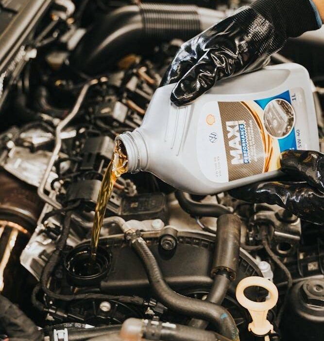 A person wearing black gloves pours motor oil from a container into a car engine.